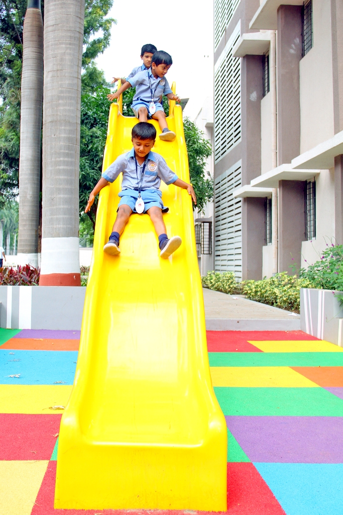 Pre-Primary Kids sliding joyfully in School Playground